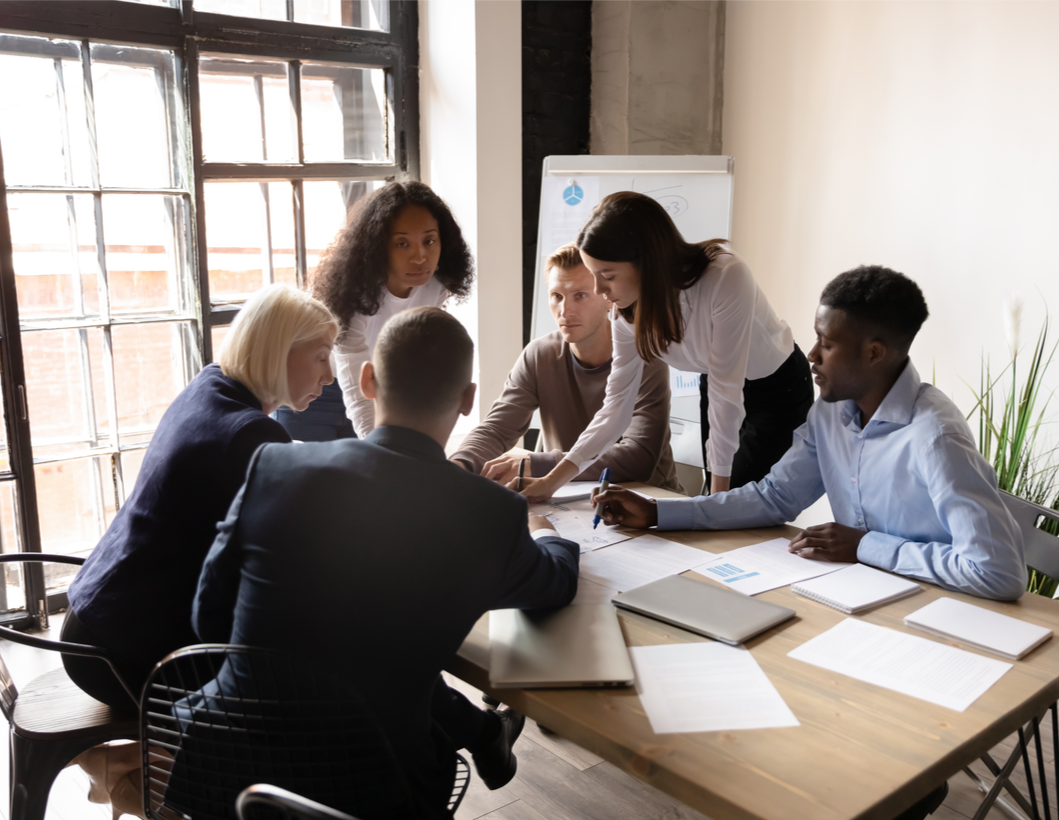 sales team in an office working on reducing their sales ramp up period